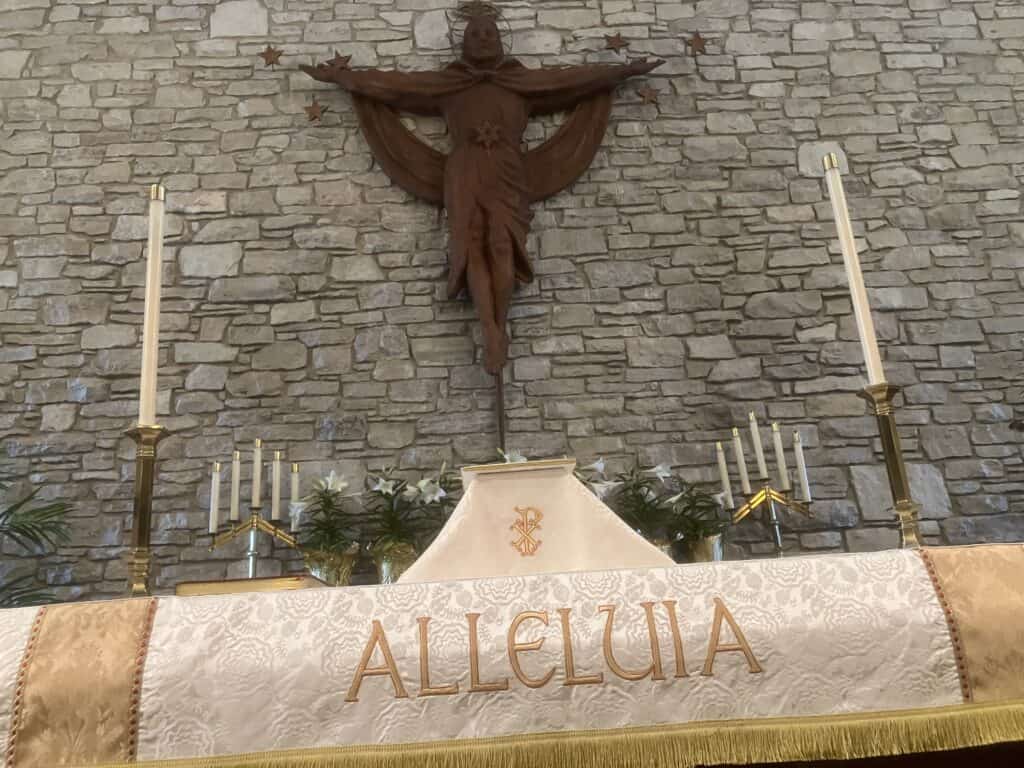 Altar at St. Thomas Episcopal Church with crucifix and white candles.