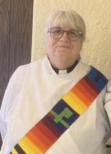 Clergy member at St. Thomas Episcopal Church wearing rainbow stole.