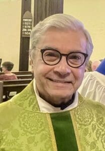 Clergy member in green vestments at St. Thomas Episcopal Church service.