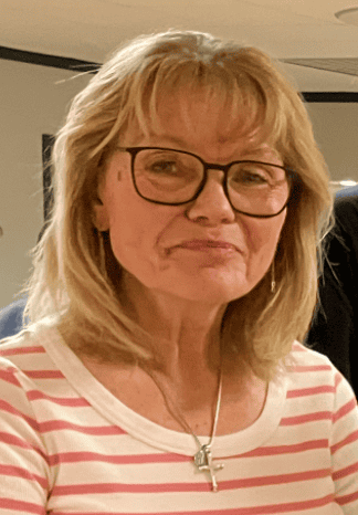Woman with glasses and blonde hair at St. Thomas Episcopal Church event.