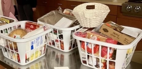 Food donation baskets filled with various packaged goods at St. Thomas Episcopal Church.